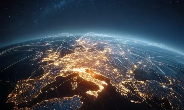 Satellite view of Earth at night with glowing city lights and white light trails connecting locations across Europe.