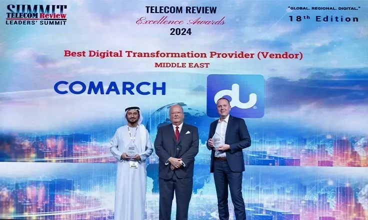 Comarch and du representatives on stage holding awards in front of the Telecom Review Excellence Awards 2024 wall.