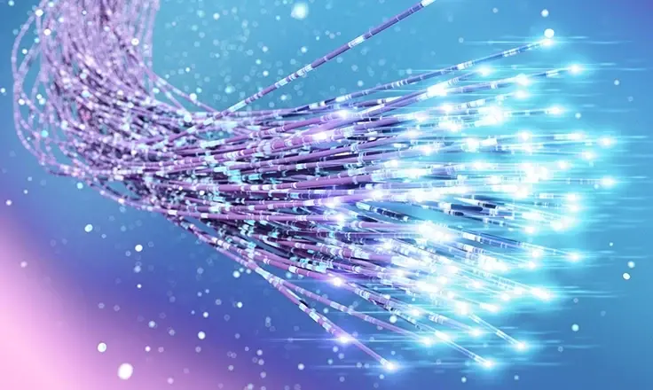 Bundled purple fiber optic cables with glowing blue light tips emitting from the ends against a blue background.