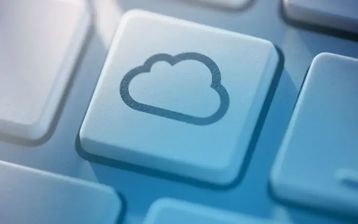 Close-up of a white keyboard button with a cloud icon.