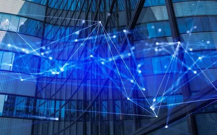 Digital network web overlaying a modern glass office building.