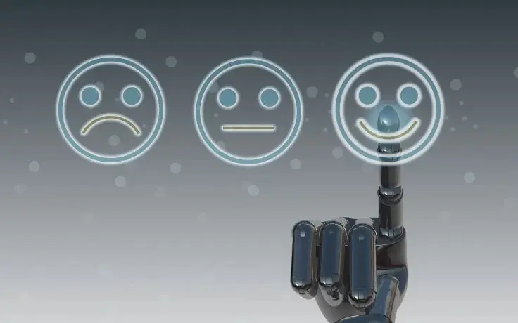 A black robotic hand points to a glowing smiling face icon among three different facial expression icons.