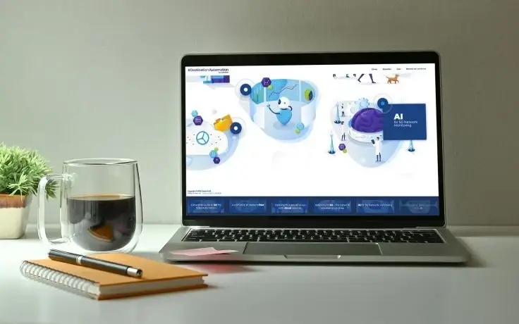 A laptop displaying a website about AI on a desk next to a cup of coffee, a notebook, and a pen.