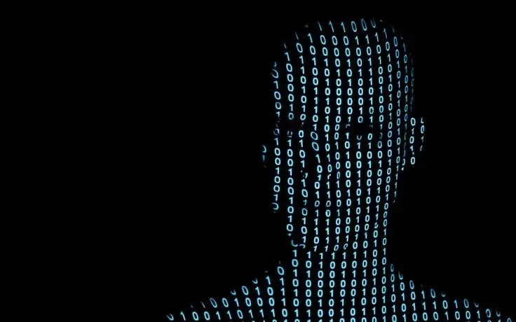 A silhouette of a human head and shoulders formed by blue binary code against a solid black background.