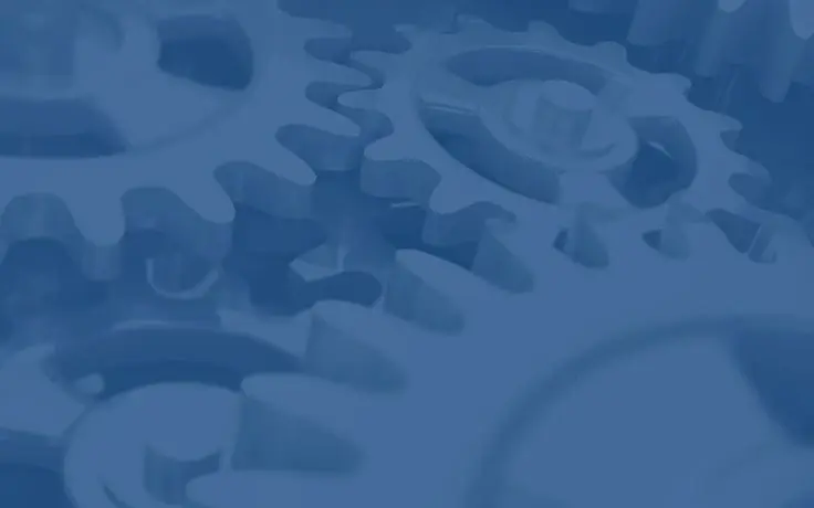 A close-up, high-angle view of interlocking blue gears and mechanical cogs.