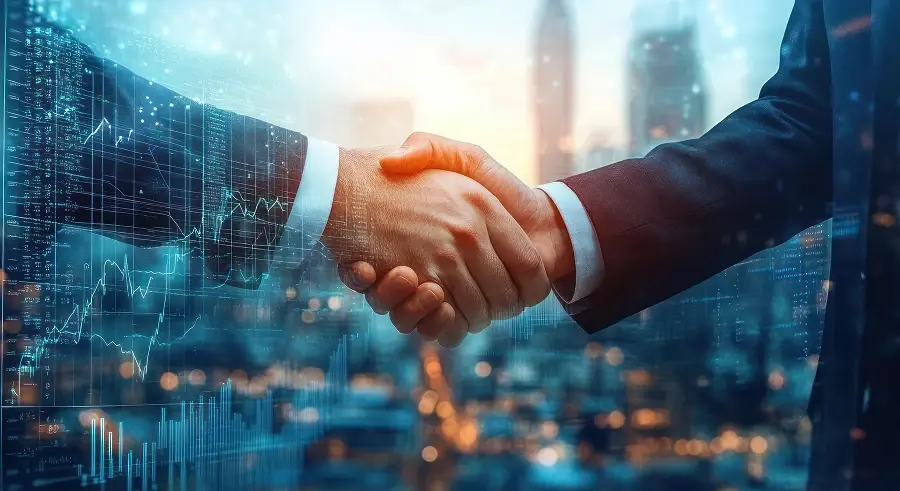 Two businessmen shaking hands, with a double-exposure effect featuring glowing digital financial charts, bar graphs, and a blurred cityscape.