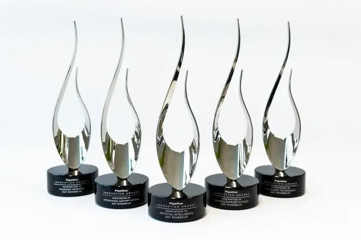 Five silver Pipeline Innovation Awards on circular black bases, each featuring a flame-like design, arranged against a clean white background.