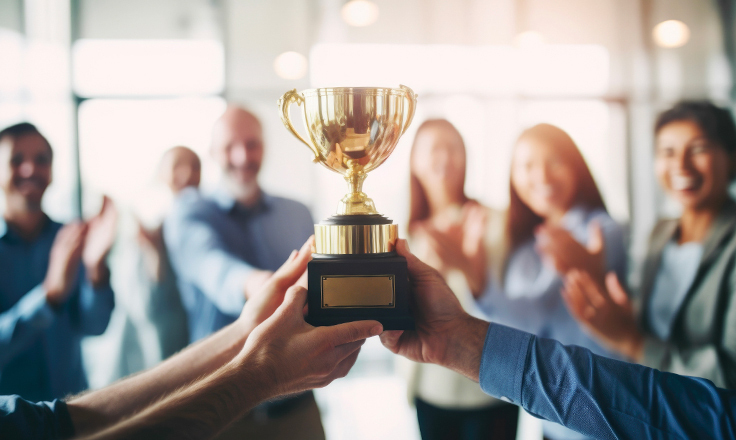 People holding a winner's trophy